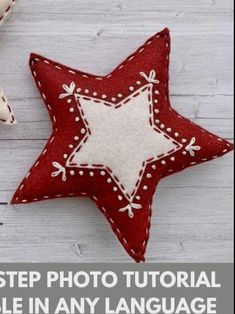 a red and white star ornament sitting on top of a wooden table