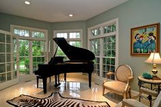 a living room filled with furniture and a grand piano