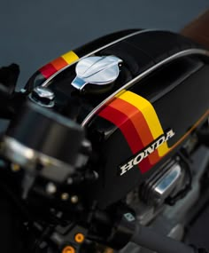 the front end of a motorcycle with a rainbow painted on it