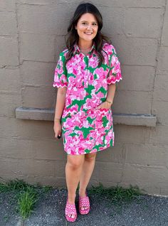 This bright and happy dress will have you searching for the next flight out to a tropical destination. With scalloped trim around the pockets and short sleeves, this floral collared cutie is nothing short or irresistible.  Relaxed fit. Preppy Collared Dresses For Spring, Pink Collared Dress For Vacation, Summer Dresses With Scalloped Edges And Short Sleeves, Collared Pink Dress For Vacation, Preppy Short Sleeve Spring Dresses, Summer Floral Print Collared Dress, Spring Short Sleeve Dress With Scalloped Edges, Pink Tropical T-shirt In Relaxed Fit, Summer Tropical Print V-neck Cover-up