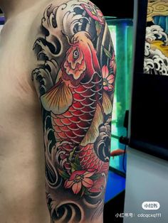 a man with a tattoo on his arm has a koi fish in the water