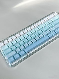 a blue and white keyboard sitting on top of a table