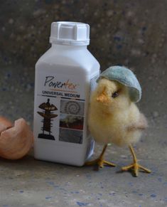 a small bird standing next to a bottle of milk