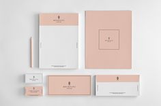 the stationery is laid out neatly on top of each other, including business cards and envelopes