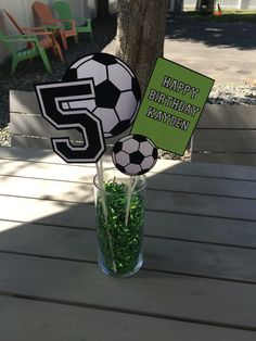 a soccer themed centerpiece sitting on top of a wooden table