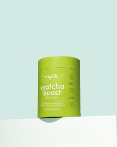 a can of matcha boast sitting on top of a white shelf against a blue background