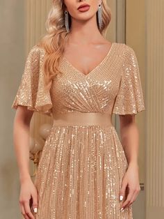 a woman wearing a gold sequin dress