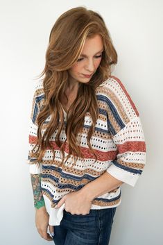 Capture the essence of warm, sunlit days with the Desert Breeze Knit Top This casual short-sleeve sweater, crafted from 100% polyester, is a perfect blend of comfort and style. The multi-color striped pattern, featuring earthy tones and soft textures, evokes the tranquil beauty of a desert sunset. With its breezy, open-knit design and relaxed fit, this top is ideal for those laid-back summer-to-fall transitions. Pair it with your favorite denim shorts or layer it over a tank for an effortlessly Striped Pointelle Knit Tops For Fall, Casual Striped Pointelle Knit Sweater, Multicolor Knit Short Sleeve Sweater, Multicolor Knit Sweater With Short Sleeves, Multicolor Short Sleeve Knit Sweater, Fall Striped Beach Sweater, Striped Knit Beach Sweater, Beach Striped Knit Sweater, Striped Sweater For Beach In Fall