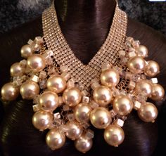 This sexy, Hollywood glamour massive bib statement necklace is a vintage piece from my personal collection. It has enjoyed many a black tie event but now it needs a new home. I will point out that it is missing one rhinestone and jump ring in the back which could easily be repaired by a jeweler. This flaw is built into the price point. The faux pearls are off white with a gold undertone. Scattered among them are clear and creamy lustrous cubes. These are attached to a rhinestone bib which adjusts from 18-21" and has a gold tone lobster claw clasp and 3" extender chain. Overall the piece is in EXCELLENT vintage condition with the exception of the noted flaw. Presented by Kat Kouture. Necklaces Inspiration, Rocker Chic Accessories, Oversized Necklace, Celebrity Stylist, Unique Pendant Necklace, Necklace Art, Statement Bib Necklace, American Fashion Designers, Chest Piece