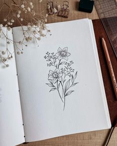 an open book with some flowers on it