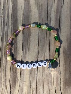 Wicked Bracelet! Pink and Green swirled beads (because "Pink Goes GOOD with Green!"), and Elphaba's "Smart Hat")  Celebrate, remember, and share every moment with our unique handmade bracelets! Perfect for pairing with show tickets, delighting a fan, or celebrating a friend's performance. Contact us for custom requests. We love spreading joy with these bracelets and hope you will too! The standard bracelet size is approx. 7.25  inches.  For other sizes, please select from the listing or message Wicked Themed Bracelets, Whimsical Pink Beaded Bracelets, Wicked Musical Bracelet, Handmade Novelty Pink Stretch Bracelet, Adjustable Pink Stretch Bracelet - Fun Style, Clay Beads, Bracelet Sizes, Handmade Bracelets, Wicked