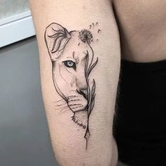 a woman's arm with a tattoo of a lion