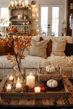 a living room filled with lots of furniture and candles on top of a coffee table