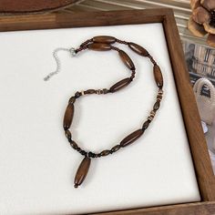 a necklace in a wooden box on a table