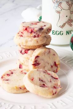 strawberry shortbread cookies stacked on top of each other in front of a coffee mug