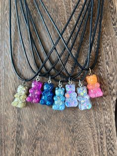 If you are looking for a nostalgic 90's or Y2K era necklace look no further!  These gummy Bear necklaces are such a fun piece to add to any wardrobe. This necklace features a black vegan leather rope style necklace and chain to adjust the length with a handmade resin gummy bear charm. Kids and adults, love them just the same. The length of this necklace is perfect for layering. The dainty gummy bear is just enough to add a pop of color to any outfit. Each gummy bear is unique and handmade with a 90s Necklace, Y2k Jewelry, Candy Jewelry, Bear Necklace, Gummy Bears, Kids Jewelry, Perfect Christmas Gifts, Chain Styles, Earring Necklace