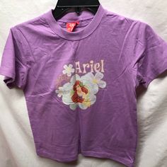 Disney Purple Tshirt T Shirt Sz Large L Ariel Little Mermaid Preowned Never Worn Condition Disney Character Print Cotton T-shirt, Disney Short Sleeve Pre-shrunk T-shirt, Disney Pre-shrunk Short Sleeve T-shirt, Disney Character Print Short Sleeve Shirt, Disney Cotton T-shirt With Cartoon Print, Disney Short Sleeve Shirt With Character Print, Cotton T-shirt With Character Print For Disney Events, Purple Character Print Short Sleeve Top, Disney Cotton T-shirt For Disney Fan Events