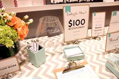 the table is set up with stationery and place cards for guests to sign in