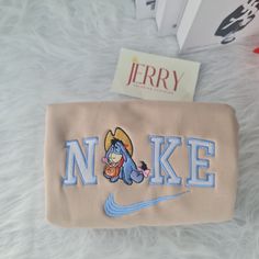 a purse with the name nnkke on it next to a book and other items