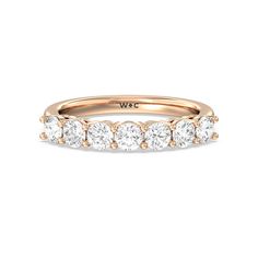 a rose gold wedding band with five round diamonds on the top and bottom, set in 18k yellow gold