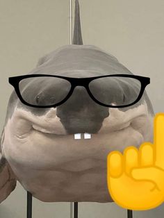 a fake shark with glasses and a peace sign in front of it