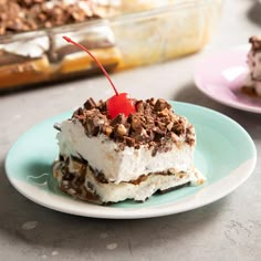 a piece of ice cream cake on a plate with a cherries garnish