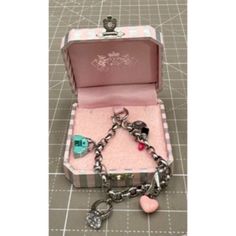 Pictured Is A Juicy Couture Enameled Charm Bracelet W/ Original Box The Bracelet Is 7 1/4" Looks Never Worn Size: Womens 7 1/4" Condition: Pre-Owned Looks As If Never Used Designer Rectangular Bracelets As Gift, Designer Enamel Jewelry As A Gift, Designer Enamel Jewelry For Gift, Luxury Pink Jewelry Collectible, Luxury Pink Collectible Jewelry, Designer Metal Jewelry For Gifts, Designer Metal Jewelry As Gift, Luxury Silver Enamel Bracelets, Enamel Jubilee Bracelet Jewelry As Gift