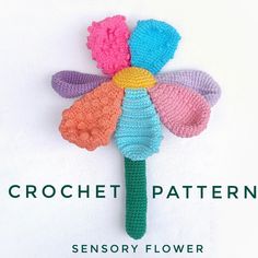 a crocheted flower with the words crochet pattern on it, in front of a white background