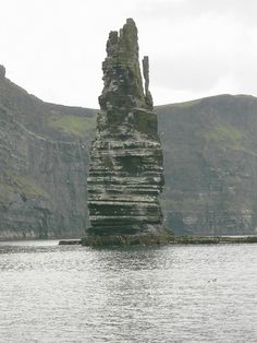 an old rock outcropping in the middle of water