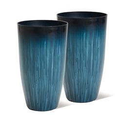 two tall blue vases sitting next to each other