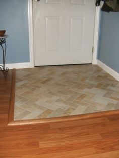 an empty entryway with wooden floors and blue walls