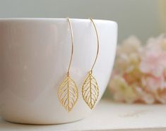 Beautiful long dangle leaf earrings. Lovely gold plated filigree Leaves hang from gold plated over brass long oval hook ear wires. These earrings easily go with any outfit, simple yet elegant.Great gift for yourself, mom, sister, friend, wife. Anniversary gift.Arrives in gift box.Measurement & Details:Total Earring length: approx. 2.6" (68mm)Color: goldFiligree leaf: 28mm x 16mmEar wires: gold plated over brass. High quality plated. Anti tarnish.For more beautiful modern earrings:http://www. Leaf Earrings Gold, Jewelry Photos, Jewelry Photography Styling, Gold Leaf Earrings, Bee Earrings, Vintage Style Jewellery, Leaf Jewelry, Gold Earrings Designs, Gold Filigree