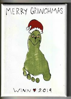 a christmas card with a green dog wearing a santa hat