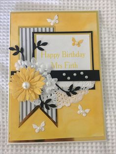 a birthday card with yellow flowers and butterflies on it's side, which reads happy birthday mrs frith