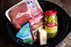 meat, cheese and pickles in a slow cooker with seasonings on the side