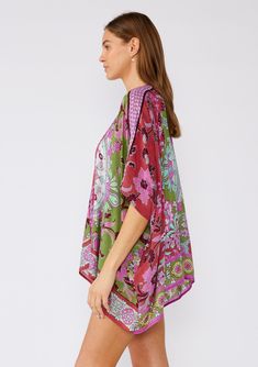 An ultra-bohemian kimono top in a stunning green and pink floral print. Floral print with contrast border Relaxed fit Half-length kimono sleeve Open front Bohemian style cover-up A must-pack style for the beach or your next vacation. Our lightweight kimono top is designed in a gorgeous mixed floral print. With an easy open front and half-length sleeves. Throw it on over your swimsuit for a quick cover-up, or style it over jeans shorts and a tank top for an effortlessly bohemian vibe. ﻿ Model is Bohemian Green Tunic Kimono, Green Flowy V-neck Kimono, Green Floral Print Tunic Kaftan, Green Tunic Kimono For Beach Cover-up, Green Bohemian Short Sleeve Kimono, Flowy Green Spring Kimono, Green V-neck Kimono For Spring, Green Bohemian Kaftan With Floral Print, Green V-neck Bohemian Kimono