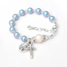 Matching set with rosary available here: https://www.etsy.com/listing/541474999/ This beautiful rosary bracelet features glowing iridescent light blue and white crystal pearls and sparkly clear crystals. All of the pearls and crystals are genuine crystal. ✻ 6mm iridescent light blue pearls represent the Hail Mary prayers. ✻ 8mm iridescent white pearl represent the Our Father prayer; accented by clear crystal rhinestones on each side. ✻ Pearls are separated by smaller diamond-shaped crystals in a Crystal Rosary, Rosary Jewelry, Iridescent Blue, Rosary Bracelet, Baptism Gifts, Christening Gifts, Swarovski Pearls, Crystal Pearls, Rosary