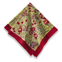 a red and green square scarf on top of a white surface with an image of flowers