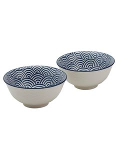 two blue and white bowls sitting next to each other