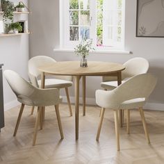 a dining table with four chairs around it