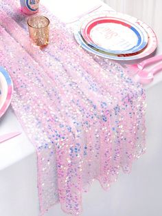 a table set with pink and blue sequins