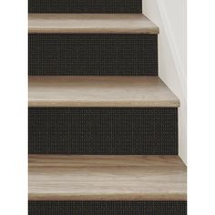 some stairs with carpet on the bottom and one way up to the top, in front of a white wall