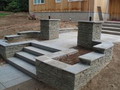 an outdoor patio with stone steps and stairs