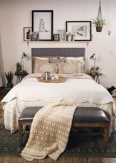 a bedroom with a large bed and pictures on the wall