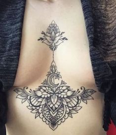 a woman's stomach with a tattoo design on it