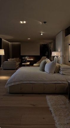 a large bed sitting in the middle of a bedroom next to two lamps on either side of it