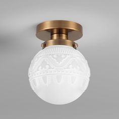 an image of a ceiling light with white glass ball on the top and gold trimmings