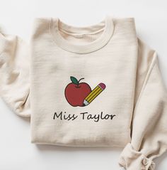 CHRISTMAS DEADLINE: We can no longer guarantee shipment by Christmas. Sorry :(  These soft unisex Comfort Colors shirts are embroidered with an apple and pencil along with your custom teacher's name :)  * 100% ring-spun cotton * Fabric weight: 6.1 oz/yd² (206.8 g/m²) * Garment-dyed * Relaxed fit * 7/8″ double-needle topstitched collar * Twill-taped neck and shoulders for extra durability * Double-needle armhole, sleeve, and bottom hems SIZING:  They're unisex but fit true to size (or very close