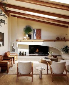 a living room filled with furniture and a fire place in the middle of a room