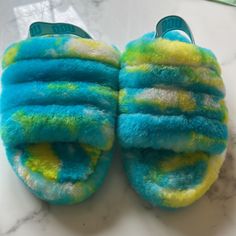 Ugg Slippers, Blue/Yellow/White Slippers. Trendy Blue Round Toe Slippers, Trendy Blue Slippers With Round Toe, Blue Round Toe Slippers For Spring, Blue Flat Slippers For Spring, Blue Synthetic Slippers For Spring, Blue Slide Slippers For Spring, Casual Blue Slide Slippers, Teal Ugg Slippers, Blue Slip-on Slippers For Spring